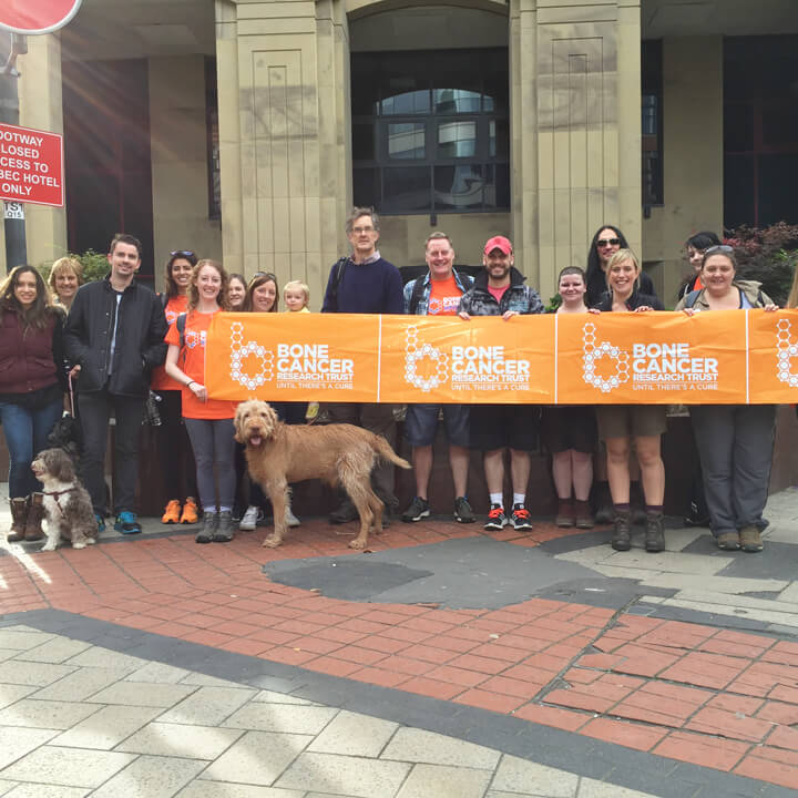 Walkers Walk Fundraising Team outside Walker Morris LLP with a Bone Cancer Research Trust banner