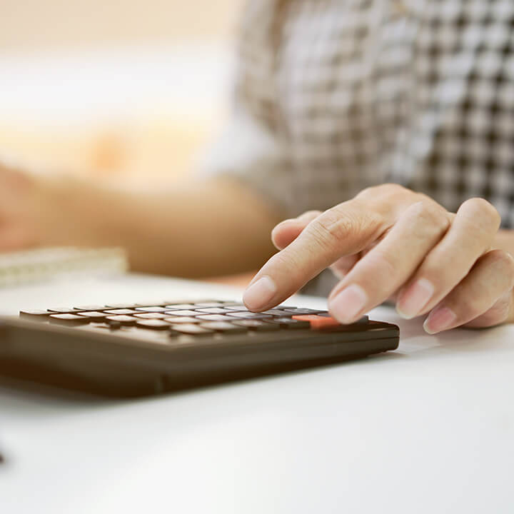 close-up-hand-on-calculator